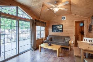 a living room with a couch and large windows at Pine Haven in Cape May Court House