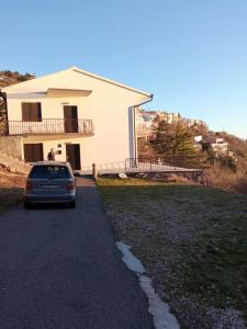 a car parked in front of a house at Marijana in Senj