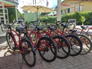 
bicycles parked next to each other on a sidewalk at Lizard King Hotel & Suites in Puerto Viejo
