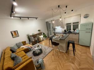 a living room with a couch and a kitchen at Number 9. in Szeged