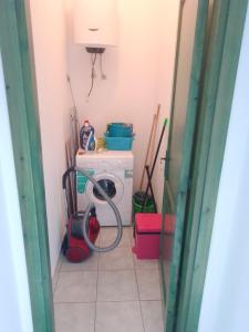 a laundry room with a washing machine in it at MaRo Apartment in Cala Liberotto