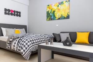 a bedroom with a bed and a table and a painting at K6 Fashion Sparta Apartment in Sparta