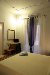 En eller flere senger på et rom på B&B La Terrazza Sul Porto