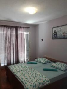 a bedroom with two beds and a window at Marijana in Senj