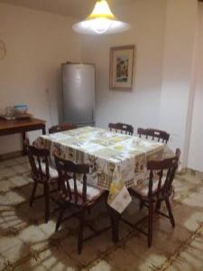a room with a table with chairs and a refrigerator at Marijana in Senj