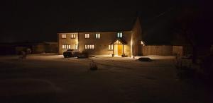 a house at night with a car parked in front of it at FIELDVIEW FARMHOUSE BED AND BREAKFAST in Colkirk