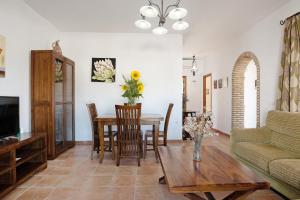 a living room with a table and a couch at El Huerto - Sólo Familias in Conil de la Frontera
