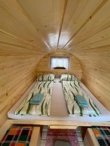 a bed in a small room in a log cabin at Donaucamping Emmersdorf in Emmersdorf an der Donau