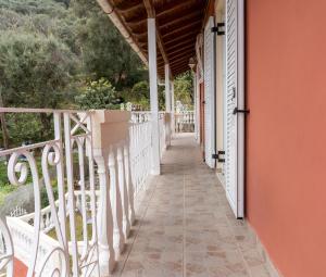 a porch of a house with an orange wall at Elisabeth house in Áno Pavliána