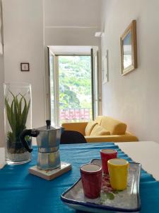 a table with a tea pot and cups on it at a Casa dei Sasso in Positano
