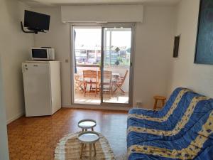 un soggiorno con divano e tavolo di Appartement avec vue exceptionnelle sur la marina a Saint-Cyprien