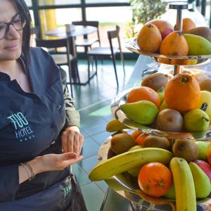 a woman standing in front of a display of fruit at Tuo Hotel in Polignano a Mare