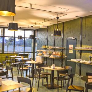 a restaurant with tables and chairs and windows at Tuo Hotel in Polignano a Mare