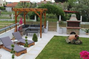 a backyard with a fire pit and a gazebo at Azure Bliss Suites in Nikiti