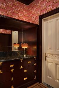 a room with a dresser with a mirror and a door at The Hotel Chelsea in New York