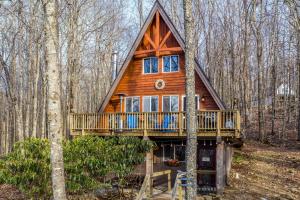 a cabin in the woods with a wrap around deck at Private Hot Tub Cabin 1 Mi to Beech Mountain! in Beech Mountain