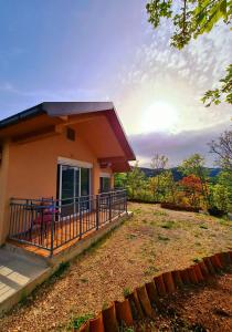 a house with a balcony with a view of a yard at S&M Apartments in Rijeka Crnojevića