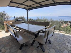 a table and chairs with a view of the ocean at Olive Stone House in Makarska