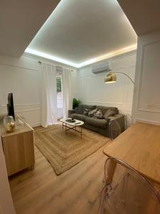 a living room with a couch and a table at Lovely Spacious Large Patio Heart of Monaco in Beausoleil