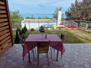 a table with a purple table cloth on a patio at SOLYMAR PRIVE in Archangelos