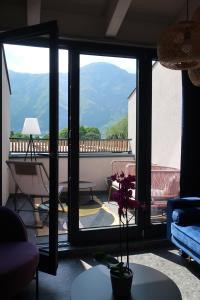 a living room with a view of a balcony at Picobello Lago in Mandello del Lario