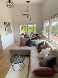 a living room with two couches and a table at Country House Peace in Drinovci