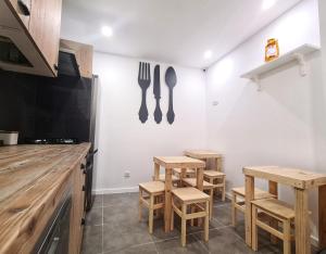 a kitchen with wooden tables and utensils on the wall at COIMBRA CITY CHARM in Coimbra