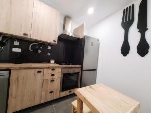 a kitchen with a white refrigerator and a wooden table at COIMBRA CITY CHARM in Coimbra +51 photos