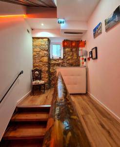 um quarto com uma parede de pedra e uma mesa num quarto em COIMBRA CITY CHARM em Coimbra
