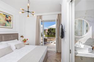 a bedroom with a bed and a bathroom with a sink at Rooms D&L, FREE Parking on-site in Dubrovnik