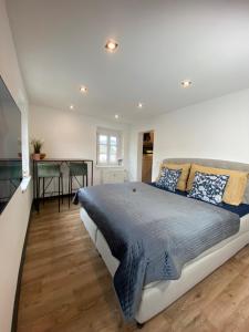 a bedroom with a large bed and a desk at #lowcosthighcomfort in Leoben
