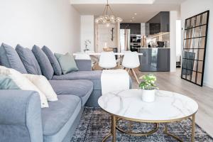 a living room with a blue couch and a table at JG35A- Perfect holiday home in good location in Marbella