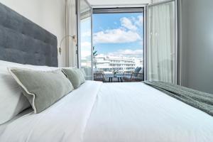 a bedroom with a white bed and a large window at JG35A- Perfect holiday home in good location in Marbella +44 photos