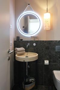 a bathroom with a sink and a mirror at Picobello Lago in Mandello del Lario