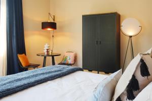 a bedroom with a bed and a cabinet and a table at Picobello Lago in Mandello del Lario