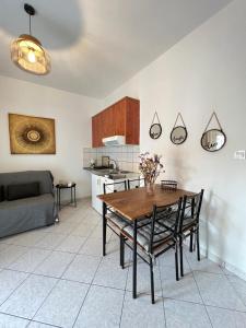 a kitchen and dining room with a table and chairs at Xanthi Apartments in Syvota
