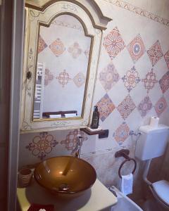 a bathroom with a sink and a mirror at Agri-Relais Sotto il cielo di Toscana only adults in Camaiore