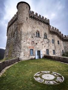 a large castle with a clock in front of it at Castello Malaspina di Fosdinovo in Fosdinovo