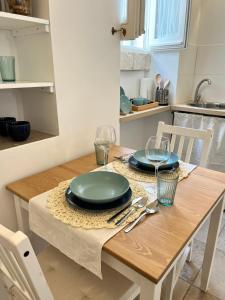 une table en bois avec des assiettes et des verres à vin dessus dans l'établissement Angoletto Bianco, à Ostuni 13 autres photos