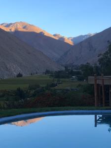 a view of a mountain range from a pool at Cabañas Elquimista in Pisco Elqui