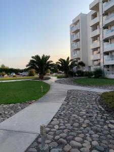 a stone walkway in front of a apartment building at departamentos tres habitaciones in La Serena