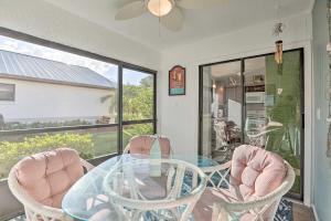 a dining room with a glass table and two chairs at Condo with Screened-in Porch, 1 Mi to Sebring Golf! in Sebring