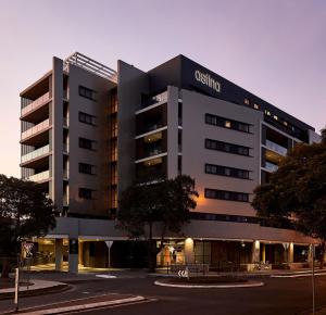 a building with a cottling sign on the side of it at Astina Suites, Penrith in Penrith
