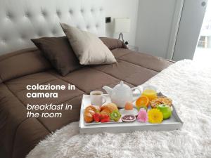a tray of breakfast in the room on a bed at B&B Giovaldi's Torino in Turin