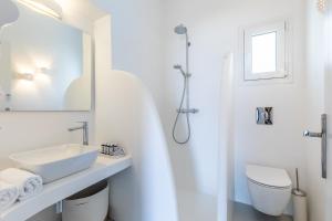 a white bathroom with a sink and a toilet at Villa Mariel Skopelos in Skopelos Town +47 photos