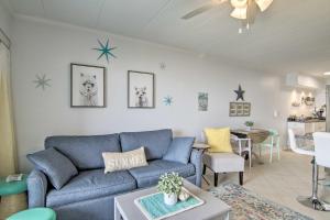 a living room with a blue couch and a table at Condo Retreat with Balcony on Ocean City Beach! in Ocean City