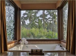 a bath tub in a bathroom with a large window at Cyberview Resort & Spa in Cyberjaya
