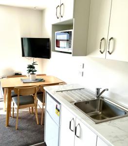 a kitchen with a sink and a wooden table at Lakeside Getaway in Otematata-2 bedroom unit - B3 in Otematata