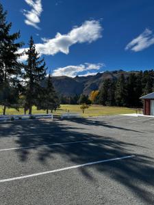 a parking lot with trees and mountains in the background at Lakeside Getaway in Otematata-2 bedroom unit - B3 in Otematata