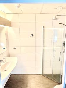a bathroom with a shower and a sink at Götaströms Värdshus in Skillingaryd